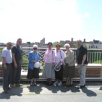 Visitors enjoy a hard hat tour of Serviam Gardens and Towers and the spectacular rooftop views. The roof will be developed into a rooftop garden with seating areas for the residents.
Visitors from L-R: Willy Valentin, Luis Pantojas,(staff from AMSU), Mary Beth Read, osu, Maru Chavez, osu, Nancy Arroyo, osu, Barbara Calamari, osu and John Reilly, Executive Director Fordham Bedford Housing Corporation.