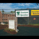 Cornerstone of Serviam Gardens will be laid in Inauguration Ceremony, which is anticipated to occur in the Fall. One side bears the Serviam insignia.